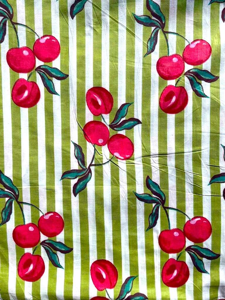 Fabric with red cherry pattern on green and white striped background, Sapling Textiles, Fabric Store Australia, Fabric online Australia