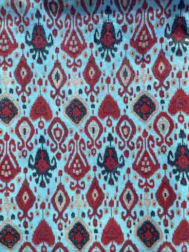 Patterned fabric with red, black, and blue design on a light blue background, Sapling Textiles, Fabric Store Australia, Indian Fabric online Australia