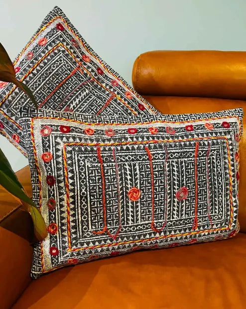Decorative pillow with intricate patterns on a brown sofa, Sapling Textiles, Fabric Store Australia, Indian Fabric online Australia