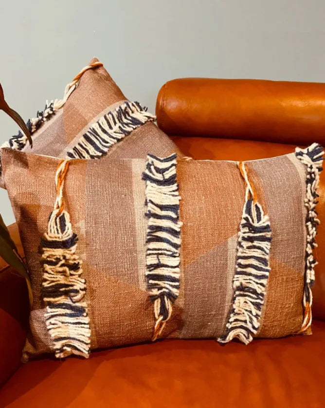 Decorative pillow with zebra pattern on a brown leather couch, Sapling Textiles, Fabric Store Australia, Indian Fabric online Australia