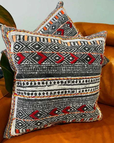 Decorative pillow with tribal pattern on a brown couch, Sapling Textiles, Fabric Store Australia, Indian Fabric online Australia