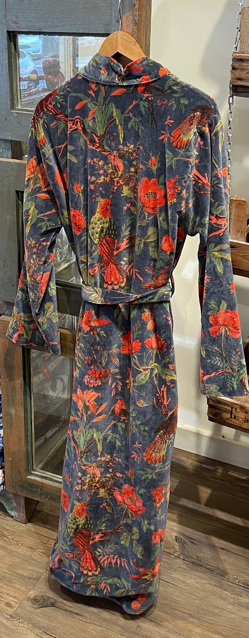 Floral patterned robe on a wooden hanger against a neutral wall. Sapling Textiles, Fabric Store Australia, Indian Fabric online Australia